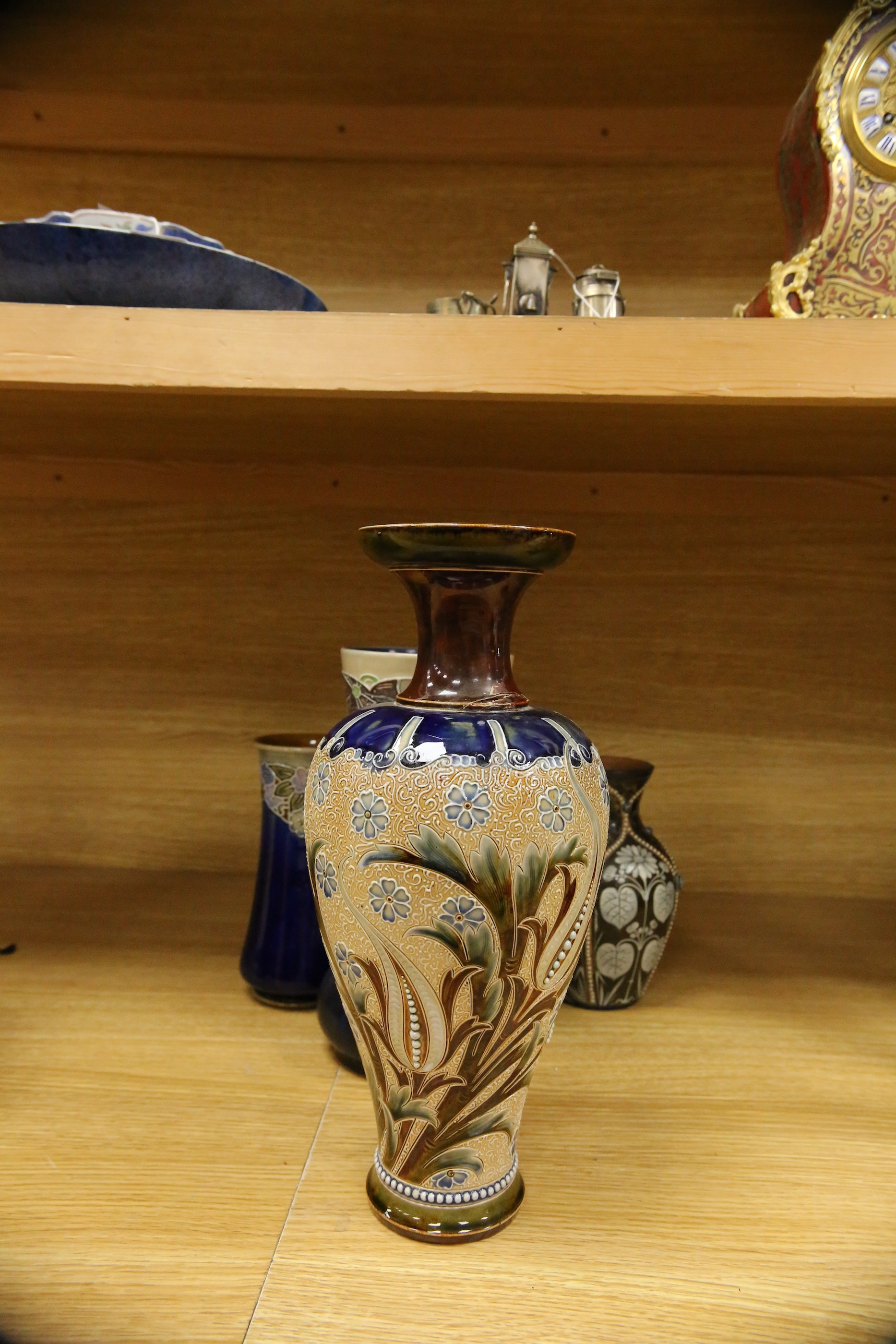 Four Royal Doulton vases and a yellow glazed jug items, tallest vase 34cm high. Condition - some crazing and faults, large vase has damage to lower neck